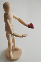 human figure offers a heart in the palm of your hand