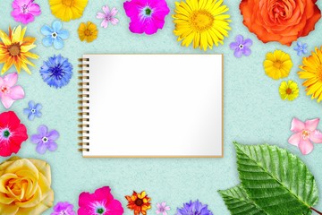 Beautiful flower frame with copybook in center on teal, sea-green design paper background. Floral composition of spring or summer flowers.