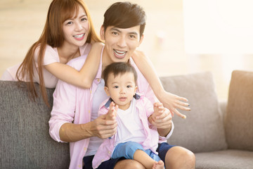 happy family mother and father playing with baby at home