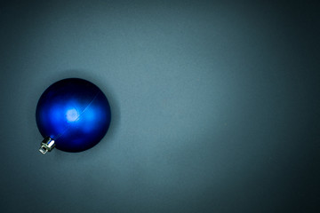 Blue christmas ball on black background.