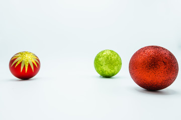 Red and green christmas balls on white.