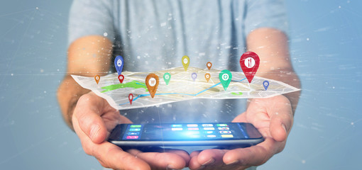 Man holding a 3d rendering pin holder on a map