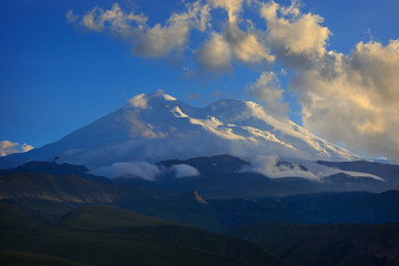 Mount Elbrus during sunset in the rays of the sun. Close-up of a mountain range in the North Caucasus in Russia.