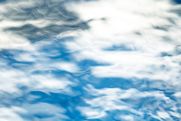 The smooth natural blue water background with bokeh  abstract on the sea or ocean,vintage and soft colored blur.