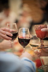 Banquet table in the restaurant. Wine glasses. People celebrating