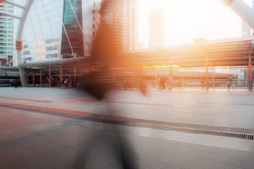 People are walking with sun shining.