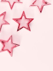 hristmas composition. Xmas pink stars on pastel pink background. Flat lay, top view, copy space 