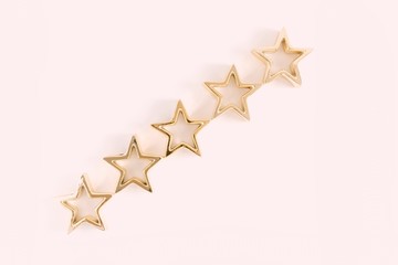 Five golden stars on pink background. Flat lay, top view, copy space 