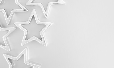 Christmas composition. Xmas silver stars on pastel gray background. Flat lay, top view, copy space 