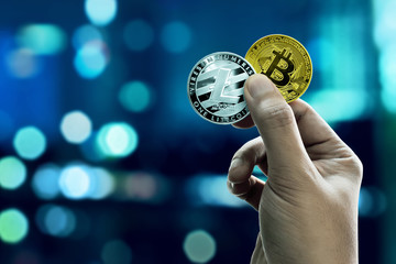Fototapeta na wymiar Hand holding bitcoin and litecoin coins
