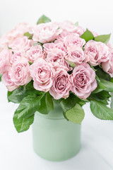 Roses lilac and pastel colors. Bright bouquet in metal bucket. concept of flower shop. vertical photo