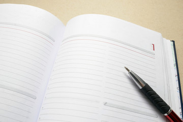 Open empty notebook with a pen on top