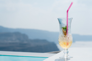 empty cocktail glass at the edge of the pool