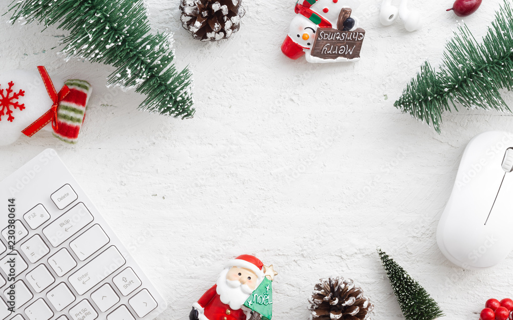 Poster flat lay office desk table with computer wireless mouse and keyboard and christmas decoration toys a