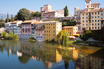Fototapeta na wymiar Bassano del Grappa (Italy, Veneto Region): houses over Brenta river shores. Color image