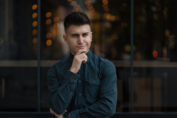 Young man close up portrait with lights in background