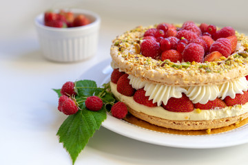 Delicious home made cake with fresh strawberries and rasberries on the white background. Isolated