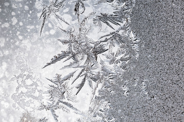 Frozen iced background. Ice pattern on the glass. Macro frost turn into negative black white photo