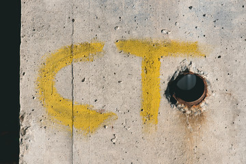 yellow ct letters on white concrete wall
