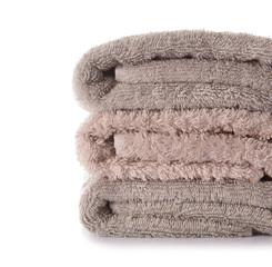 Stack of clean soft towels on white background