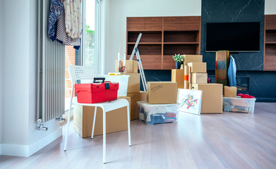 Large living room with stack of moving boxes