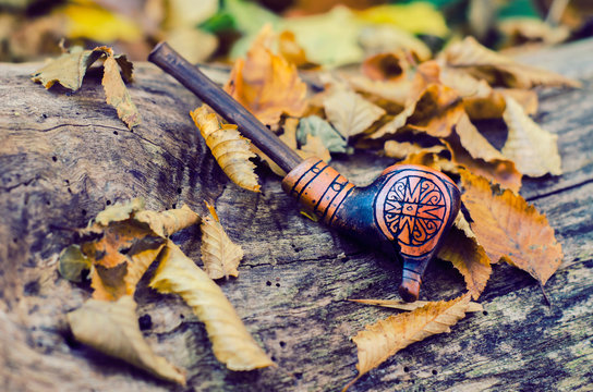 A tube for smoking, made of clay, using Trypillian ornament.
