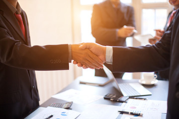 Asia business people shaking hands, finishing up meeting