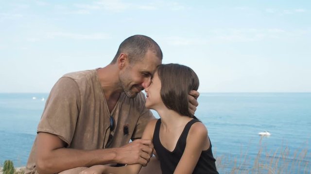 Happy family on vacation. Father with daughter on the background of the sea.