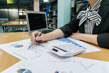 Young women are checking the company's finances to prepare them for the big deal.