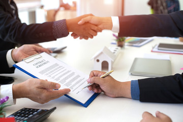 Asia business people shaking hands, finishing up meeting