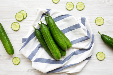 Fresh raw green cucumbers, top view. Flat lay, from above, overhead.