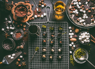 Confectionery or patisserie concept. Preparation of pralines with prunes soaked in rum and stuffed...