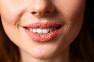 Smiling female closed red lips closeup