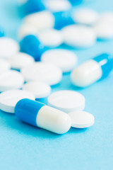 Prescription pills on blue background.