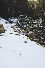 The river in the Carpathian Mountains in the winter. Dragobrat Snow drops Winter fairy tale. Traveling