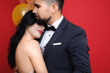 Elegant man embracing woman