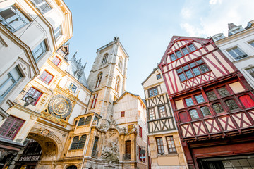 Street view with ancient buildings and Great clock on renaissance arch, famous astronomical clock...