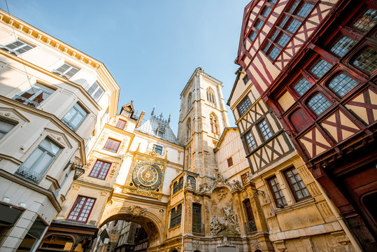 Street view with ancient buildings and Great clock on renaissance arch, famous astronomical clock in Rouen, the capital of Normandy region - Powered by Adobe