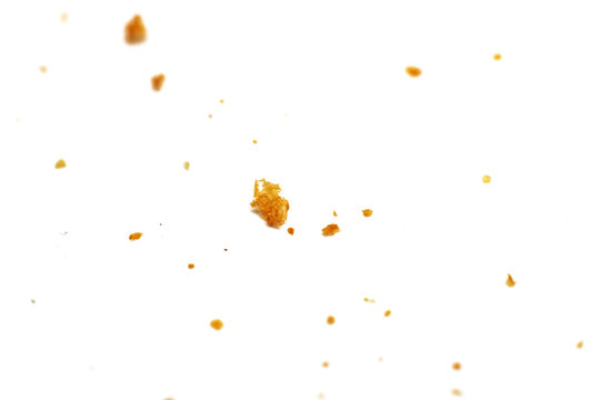 White bread crumbs on a white background close up