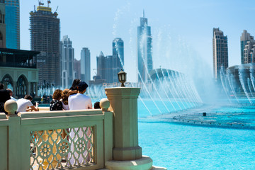 Dubai, United Arab Emirates - March 26, 2018: People gather around the Dubai mall fountain to see...