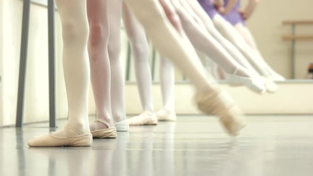 Ballerinas feet in pointes. Group of ballerinas having rehearsal at ballet class. Ballet dance pointe technique.