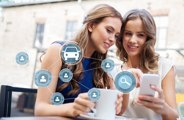 car sharing, modern technology and people concept - happy young women with smartphone drinking...