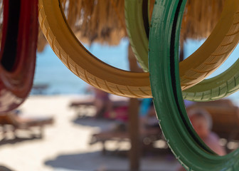 multi-colored painted tires from cars, motorbikes, scenery on the beach