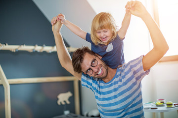 Father Giving Daughter Piggyback Ride
