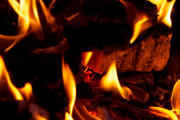 burning red wood, charcoal covered with fire