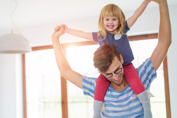 Father Giving Daughter Piggyback Ride

