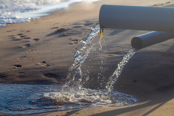 pipe, throwing waste into the sea