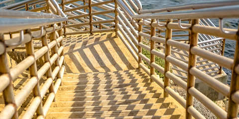 Stairs going down the calm ocean in Sunset Cliffs