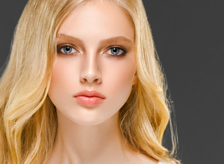 Blonde woman face closeup with healthy skin and beauty makeup