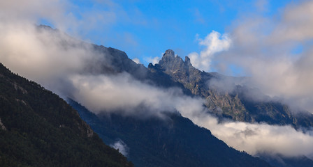 Clouds over the rocky ridge of the mountainous region of the North Caucasus in Russia.